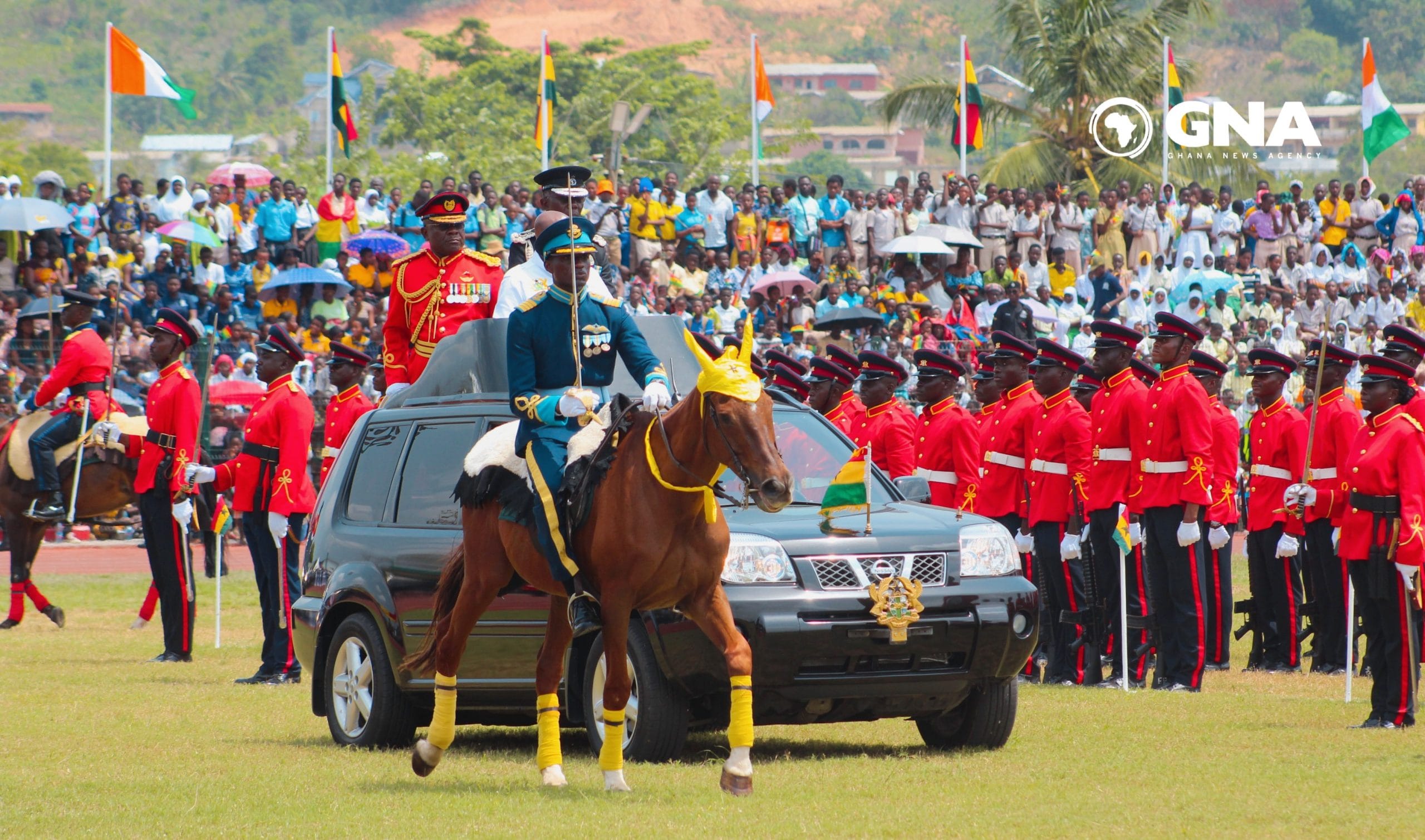 Ghanaians waving national flags at Independence Day parade, Black Star Square Accra