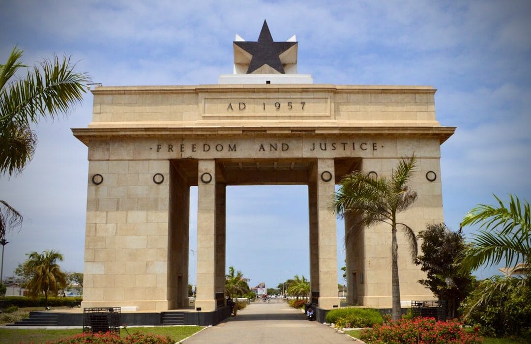 Ghana IMF deal 2026 economic recovery analysis showing Accra business district and financial charts