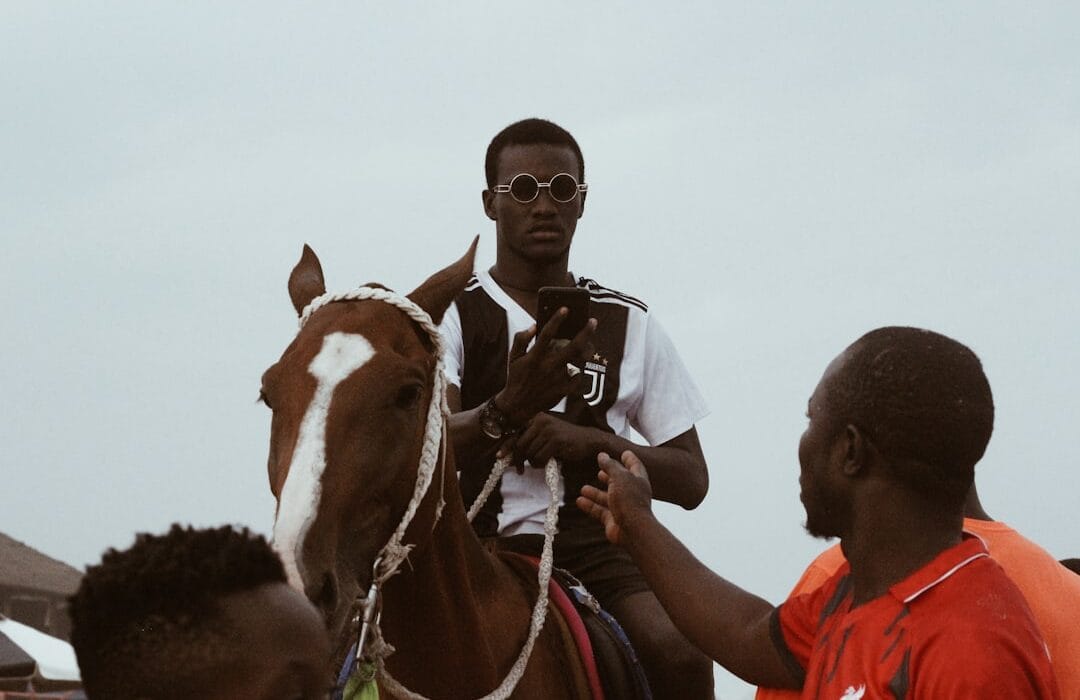 Young Ghanaians on smartphones engaging in sports betting Ghana 2026 at a betting shop in Accra